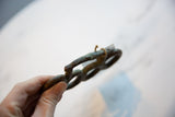 Side view showing the aged patina and handmade texture of the vintage bronze knuckles.