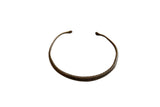 Antique African bronze cuff bracelet with a handmade snakeskin pattern and aged patina.