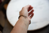 Back view of the antique African bronze cuff bracelet worn on a wrist.