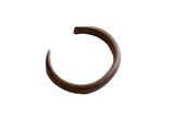 Antique African copper snake cuff bracelet with a simple C-shape and dark, aged patina.