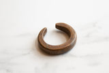 Aged patina and incised marks on a handmade antique African bronze cuff.