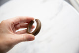Side view of the small antique bronze cuff, highlighting its etched design details.
