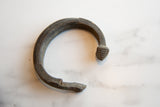 Profile of the antique bronze snake cuff showing its textured scales and damaged end.