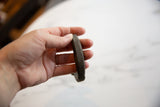 Side profile showing the handcrafted texture and thickness of the antique bronze cuff.