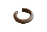 Antique African copper cuff bracelet with a heavy, rustic form and a dark, time-worn patina.