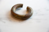 Side profile of the antique African bracelet highlighting its open cuff shape and timeworn patina.