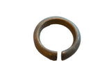 Antique African bronze cuff bracelet with a thick, rounded form and textured, age-worn patina.