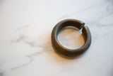 The solid, heavy form of a collectible antique African bronze cuff bracelet.