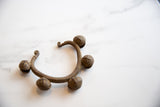 Textured copper alloy Lobi bell cuff bracelet with antique patina.