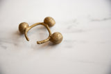 Hand-worked texture on the bell and open end of a vintage Lobi cuff.