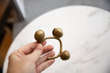 Vintage Lobi bronze bell cuff held in hand, showing its scale and handcrafted form.