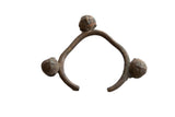 Vintage African Lobi bell cuff bracelet in bronze alloy showing a rustic texture and three figural bells.