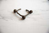 Angled view of the vintage African Lobi bronze bell cuff's textured surface.