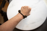 Vintage Lobi bell cuff bracelet with a dark bronze patina worn on a wrist, viewed from above.