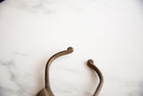 Handcrafted scrolled terminals of the vintage African bronze cuff bracelet.