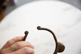 Close-up of the hand-forged spiral terminals on the vintage bronze cuff.