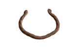 Antique African copper cuff bracelet with a hand-twisted design and aged patina.
