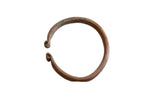 Antique African copper snake cuff bracelet with a weathered, oxidized patina.