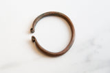 Antique African copper snake cuff with textured ends and a rich aged patina.