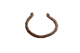 Antique African copper cuff bracelet with a hand-forged twisted design and aged patina.