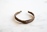 Twisted double bands and time-softened texture of the antique African iron cuff bracelet.