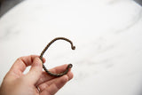 The sculpted, twisted form of an antique African copper alloy currency bracelet.