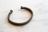 Antique African bronze cuff with a visible double band and time-softened patina.