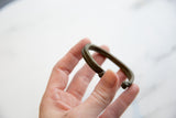 Antique double-banded African cuff showing its aged bronze patina and open shape.