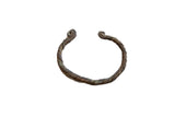 Antique African cuff bracelet with a twisted, oxidized copper body and coiled spiral ends.