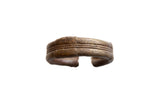 Antique African bronze and copper striped cuff bracelet with a handcrafted, etched texture.