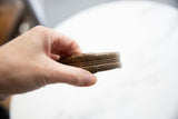 The substantial build and hand-etched striped texture of an antique bronze cuff.