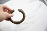 Overhead view of the antique African cuff's curved form and textured bronze finish.