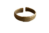 Antique African bronze cuff bracelet with a hand-etched stripe design and aged golden patina.