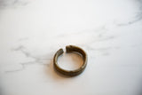The substantial, rounded form of an antique African bronze currency bracelet.