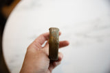 Profile of the thick, antique African bronze cuff, detailing the construction seam and time-worn patina.