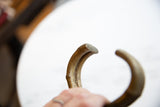 Detailed view of the antique bronze bracelet's hand-formed and flattened tip.