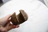 Antique African copper cuff held open, revealing its textured patina and wide shape.