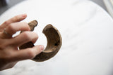 The open profile and coarse texture of the antique African cuff bracelet.