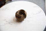 Curved profile and textured surface of the antique handmade African copper cuff bracelet.