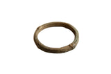 Antique African oxidized bronze bracelet with intricate geometric patterns and a time-worn patina.
