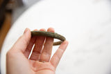 Close view of the antique bronze bracelet's ribbed texture and oxidized finish.