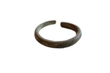 Antique African cuff bracelet in oxidized copper and bronze with a barber pole design.