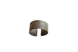 Antique African bronze alloy cuff bracelet with faded geometric patterns and rich patina.