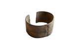 Antique African bronze cuff bracelet with a wide, textured band and dark, time-worn patina.