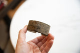 Textured surface and raised geometric motif on the antique African bronze bracelet.