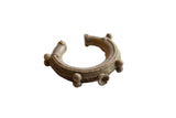 Antique African bronze cuff bracelet with detailed craftsmanship, raised spheres, and an aged patina.
