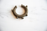 An overhead view of the antique bronze cuff, highlighting the textured patina and raised details.