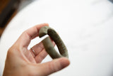 Hand-wrought curve and textured oxidized patina on an antique bronze African cuff.