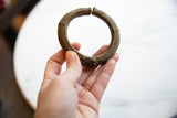 Collectible African bronze cuff shown in hand to illustrate its scale and textured patina.