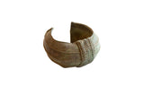 Antique African wide cuff bracelet in oxidized bronze with central braided detailing.